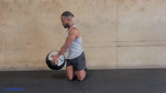قطع الخشب بالكرة الطبية أثناء الركوع