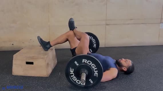 Barbell Feet Elevated Figure Four Glute Bridge